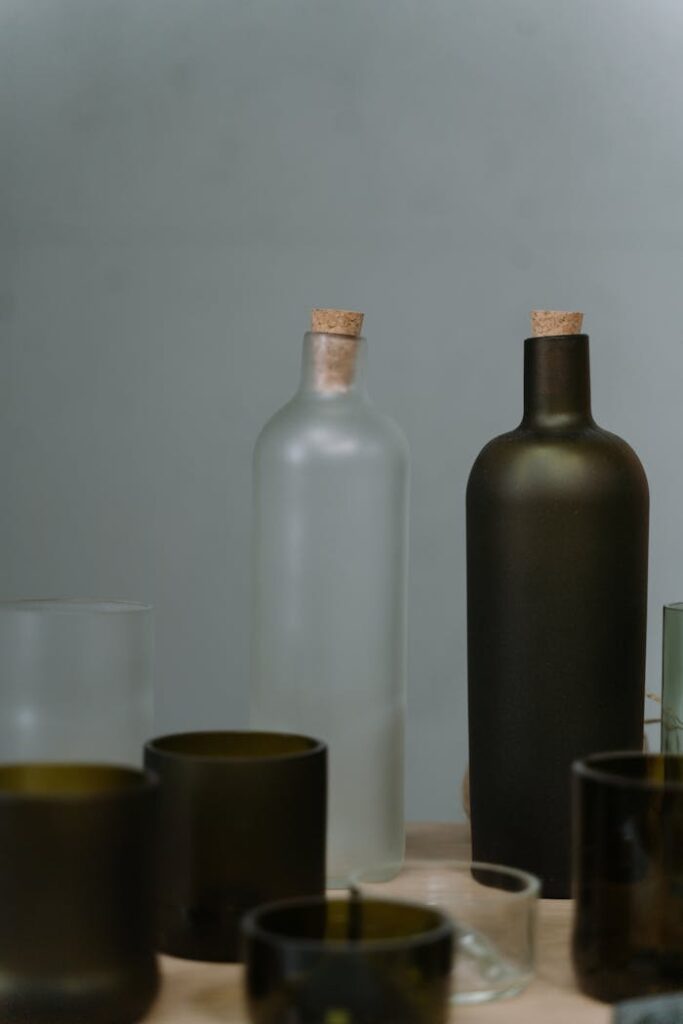 pexels photo 7223499 An artistic still life of various glass bottles with corks on a minimalist background.