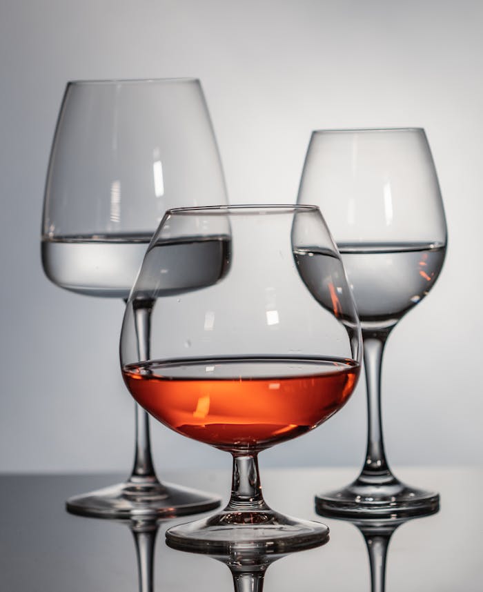 pexels photo 9202853 Close-up of three glasses with wine and water in a studio setting, showcasing elegance and sophistication.